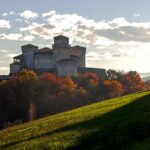 Castello medievale in Umbria con tavola imbandita per una cena storica.